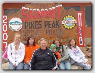 mom and the kids posing in front of the summit sign